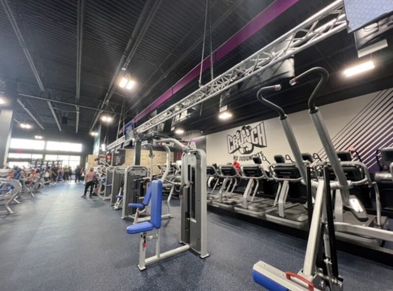 Crunch Fitness training floor with cardio and strength equipment.