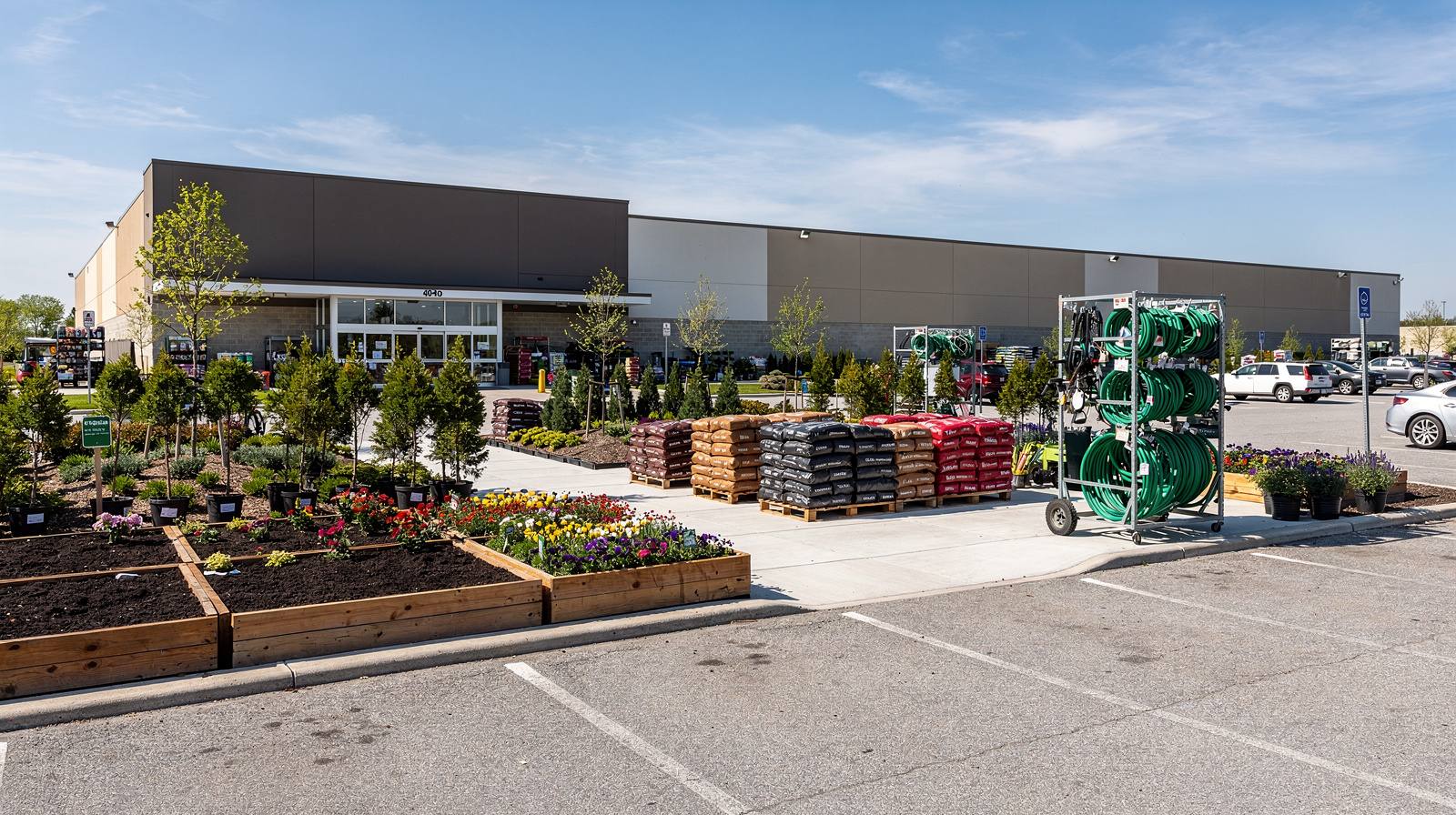 Home improvement retail store exterior with organized outdoor garden display area