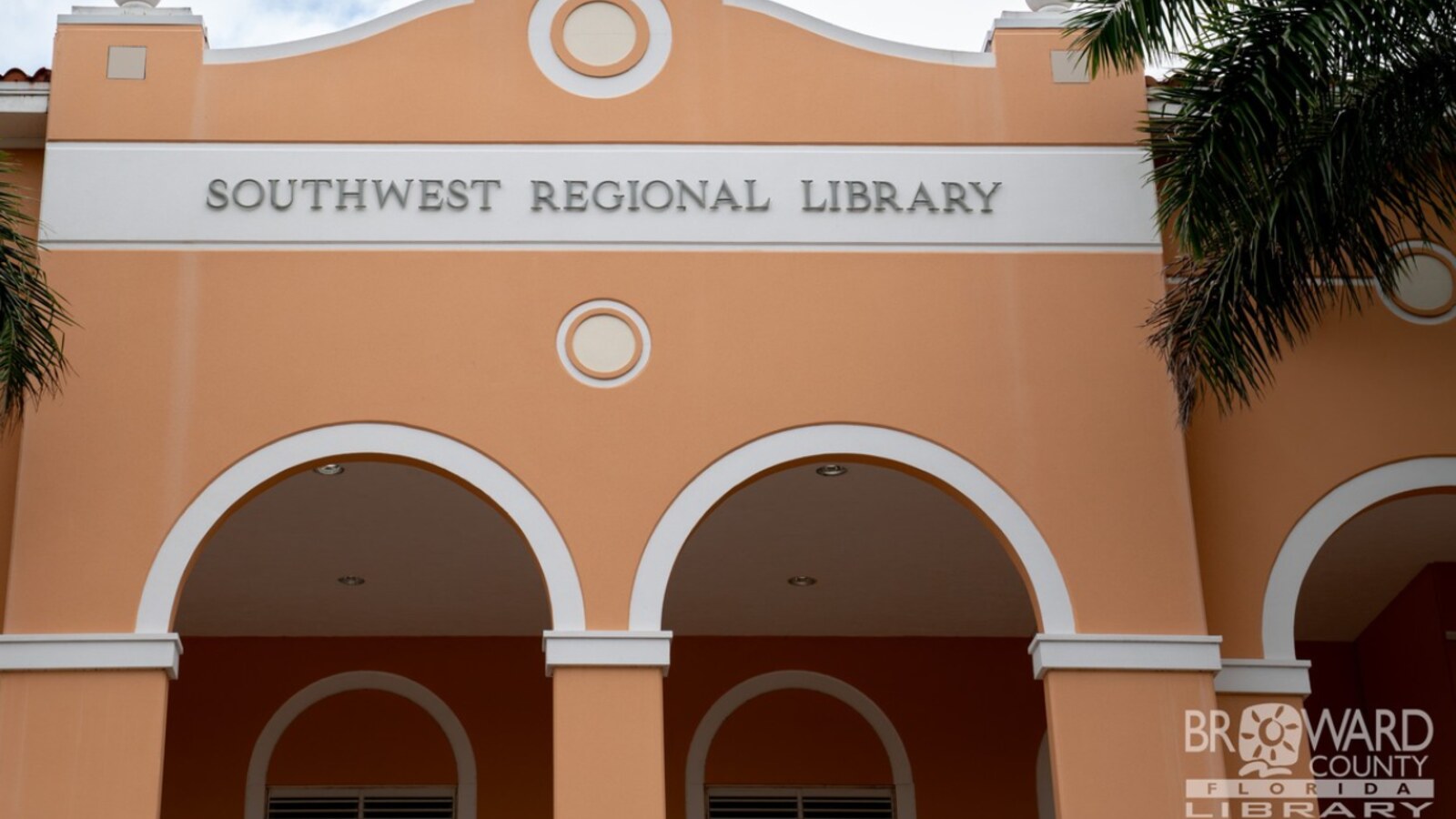 Southwest Regional Library — official Broward County Library exterior with peach-colored facade and arched entryways