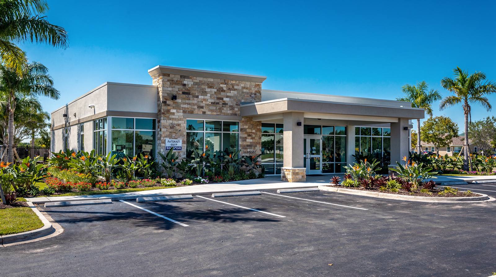 Representative exterior of a comprehensive animal hospital with stone and stucco facade and covered entrance