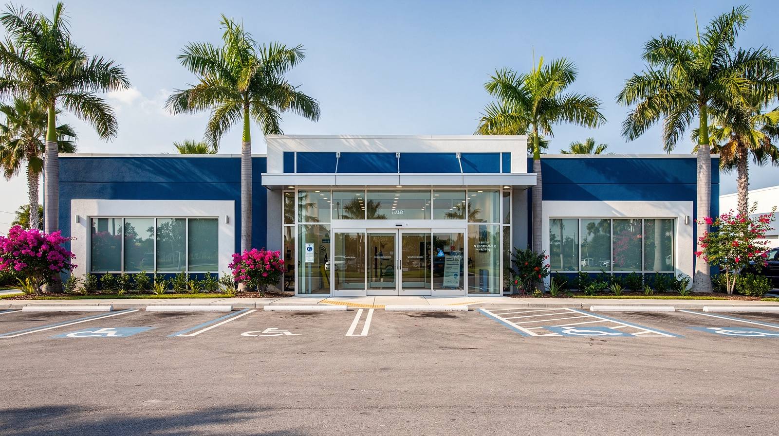 Representative exterior of a full-service veterinary center with blue and white color scheme and tropical landscaping