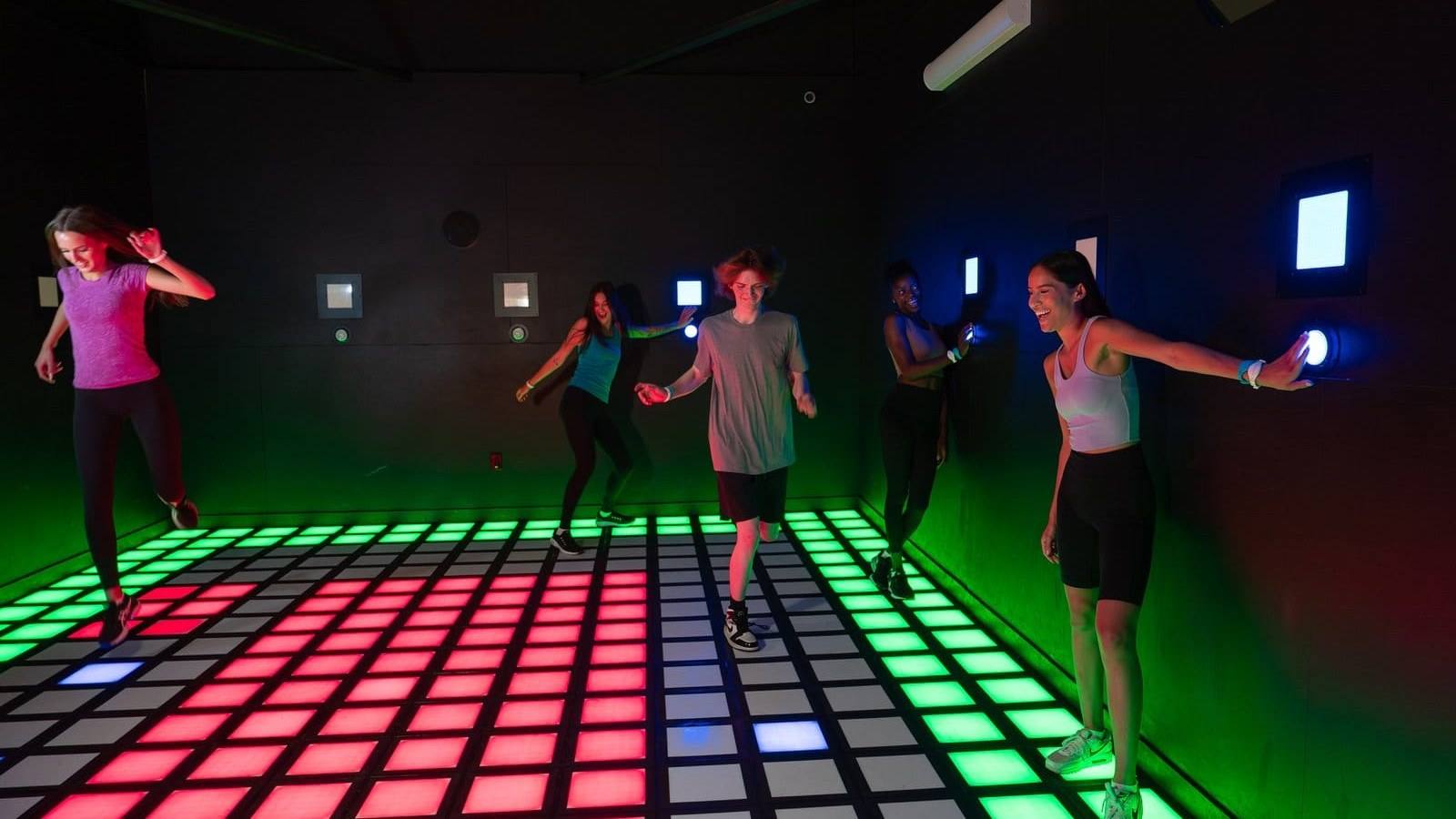 Activate Pembroke Pines immersive gaming facility with neon-lit interactive game rooms