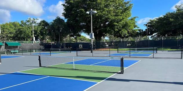 Tennis and pickleball courts at Silver Lakes South Park in Pembroke Pines with palm trees and clear blue sky