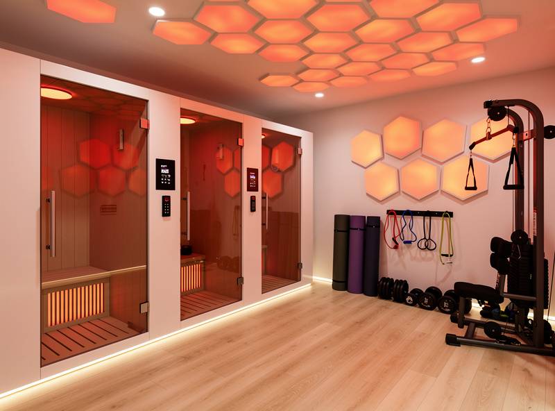 Representative infrared sauna fitness studio with glass-door pods and warm amber lighting — editorial placeholder image, not an actual photo of this business
