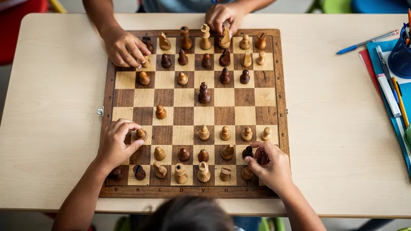Children concentrating on chess games during an enrichment class
