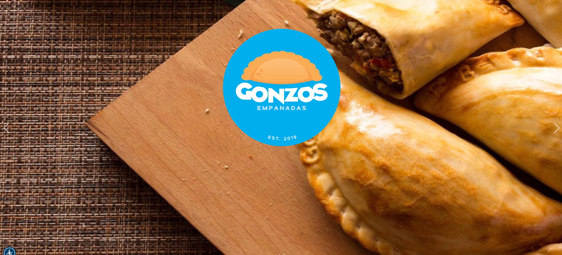 Gonzo's Empanadas logo over freshly baked golden empanadas on a wooden cutting board, one cut open to show the savory meat filling