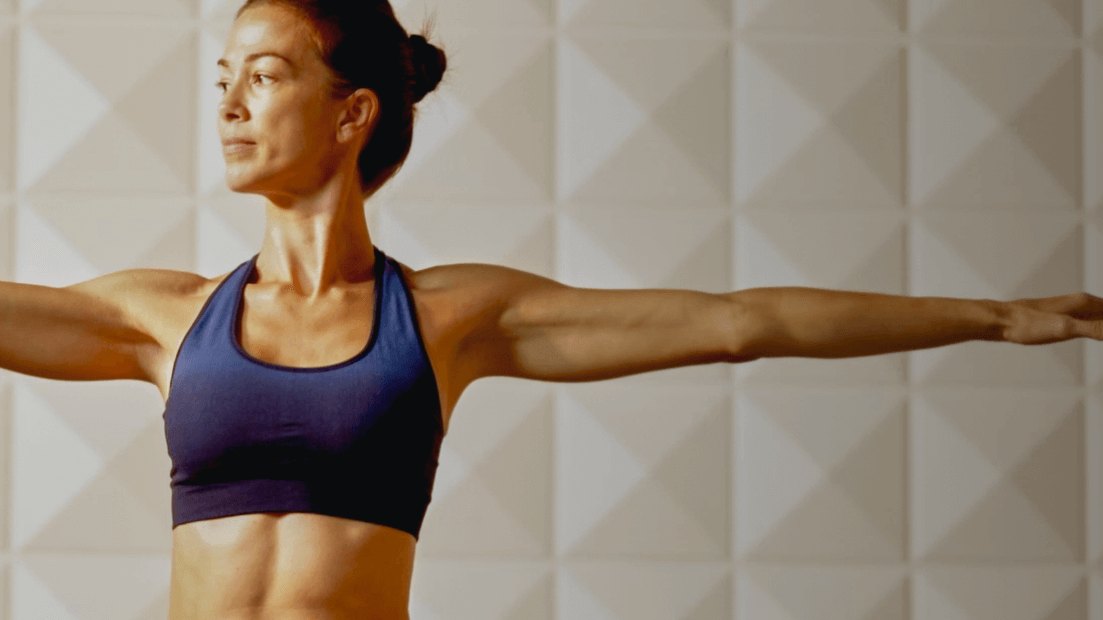 Yoga Joint — instructor demonstrating a standing yoga pose in the studio (official brand photo from yogajoint.com)